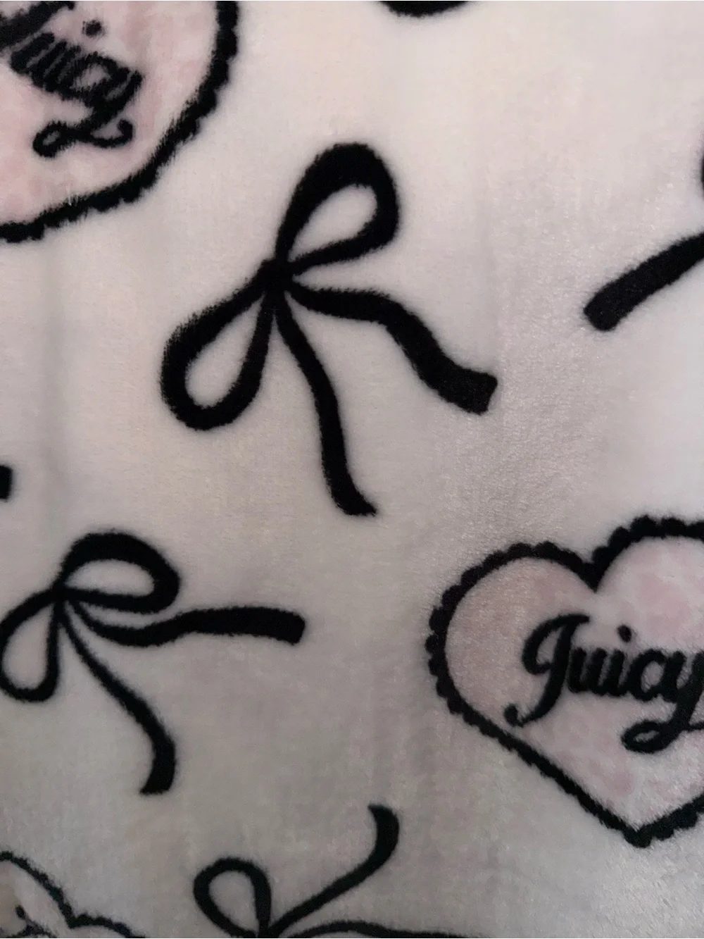 Juicy Couture White Fleece Throw with Black Heart & Bow Print light pink blanket